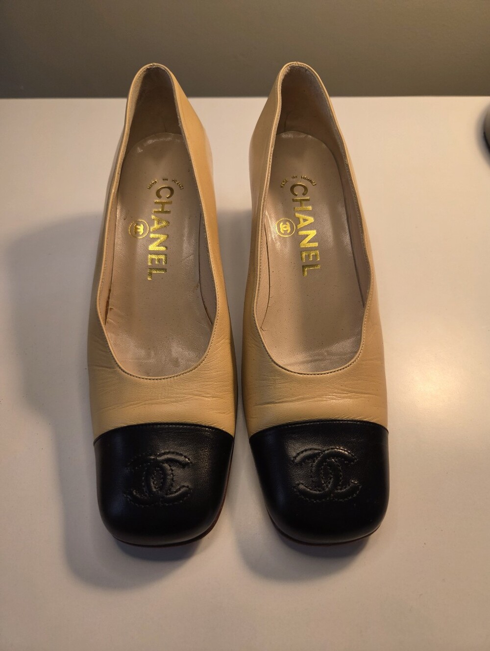CHANEL Beige and Black Two-Tone Leather Cap-Toe Pumps